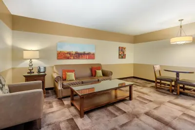 a living room with a couch and a table at Carlton Oaks Lodge, an Ascend Collection Hotel in Santee