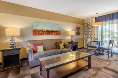 a living room with a couch and a table at Carlton Oaks Lodge, an Ascend Collection Hotel in Santee