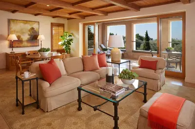a living room with a couch and a table at The Resort at Pelican Hill in Crystal Cove