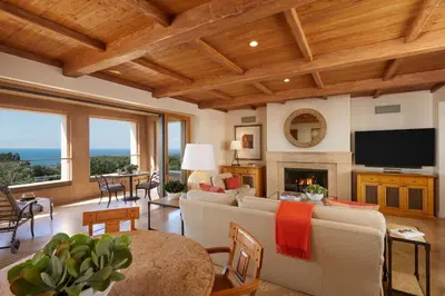 a living room with a couch and a fireplace at The Resort at Pelican Hill in Crystal Cove