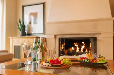 a living room with a table with food and wine glasses at The Resort at Pelican Hill in Crystal Cove
