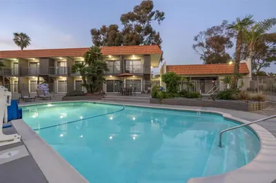 a large swimming pool in front of a building at Best Western Oceanside Inn in Oceanside