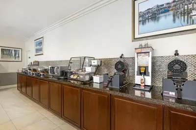 a bar in a restaurant with a counter with at Best Western Oceanside Inn in Oceanside