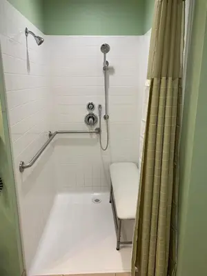 a bathroom with a shower with a toilet and a sink at Rancho California Inn Temecula in Temecula