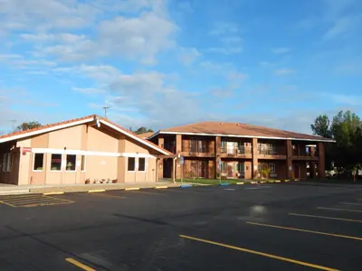 an empty parking lot in front of a building at Rancho California Inn Temecula in Temecula