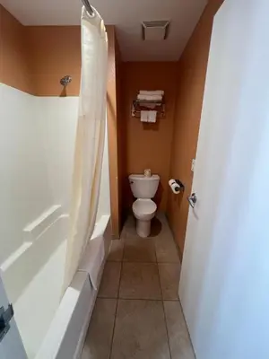 a bathroom with a tub and a toilet and a shower at Rancho California Inn Temecula in Temecula