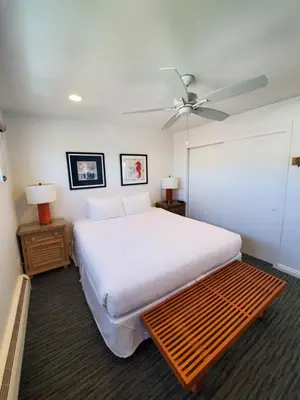 a bedroom with a large bed and a ceiling fan at Sea Horse Resort in San Clemente