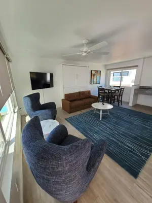 a living room with two chairs and a couch at Sea Horse Resort in San Clemente