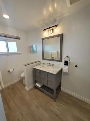 a bathroom with a sink and a mirror at Sea Horse Resort in San Clemente