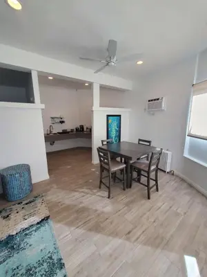 a dining room with a table and chairs at Sea Horse Resort in San Clemente
