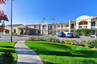 a street in a residential neighborhood with cars parked at Lamplighter Inn & Suites at SDSU in San Diego