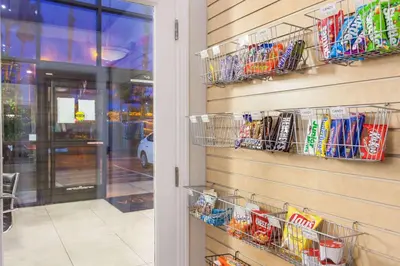 a store with baskets of snacks on the wall at Ramada by Wyndham Oceanside in Oceanside