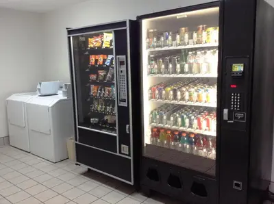 a soda vending machine filled with lots of drinks at Ramada by Wyndham Oceanside in Oceanside