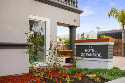 a sign for the hotel oconee in front of a building at The Hotel Oceanside in Oceanside