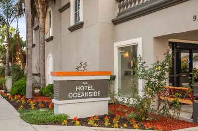 a sign for the hotel oconee in front of a building at The Hotel Oceanside in Oceanside