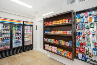 a store aisle with two refrigerators and drinks at The Hotel Oceanside in Oceanside
