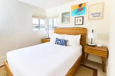 a bedroom with a large bed and two lamps at Laguna Surf Lodge by SCP Hotels in Laguna Beach