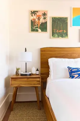 a bedroom with a bed and a table with a lamp at Laguna Surf Lodge by SCP Hotels in Laguna Beach