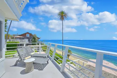 a balcony with a bench and a view of the ocean at Laguna Surf Lodge by SCP Hotels in Laguna Beach