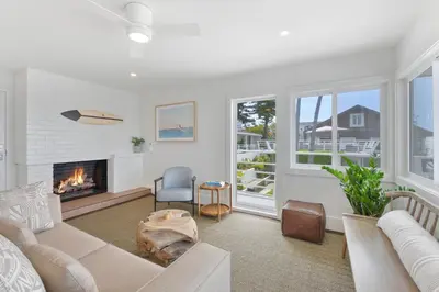 a living room with a couch and a fireplace at Laguna Surf Lodge by SCP Hotels in Laguna Beach