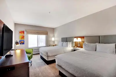 a hotel room with two beds and a desk at Hampton Inn & Suites by Hilton Hemet Menifee Murrieta in Hemet