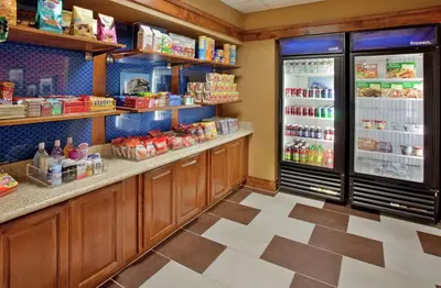 a grocery store aisle with a refrigerator and food at Hampton Inn & Suites by Hilton Hemet Menifee Murrieta in Hemet