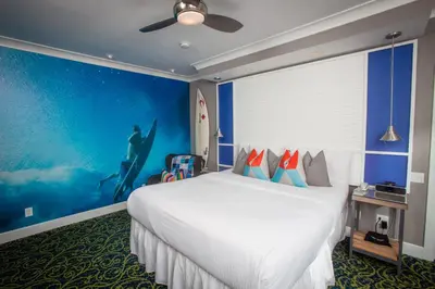 a bedroom with a large bed and a large painting at La Casa Del Camino in Laguna Beach