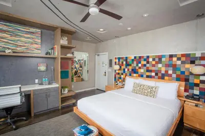 a bedroom with a bed and a desk and a computer at La Casa Del Camino in Laguna Beach
