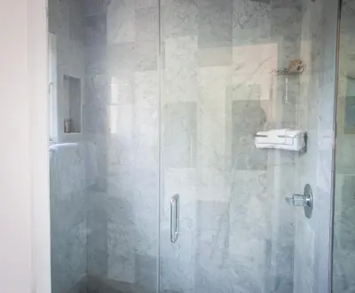 a shower with a glass door in a bathroom at La Casa Del Camino in Laguna Beach