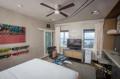 a bedroom with a bed and a flat screen tv at La Casa Del Camino in Laguna Beach