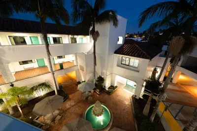 an aerial view of a building with palm trees and umbrellas at Casablanca Inn in San Clemente