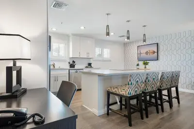 a kitchen and dining room with a table and chairs at Casablanca Inn in San Clemente