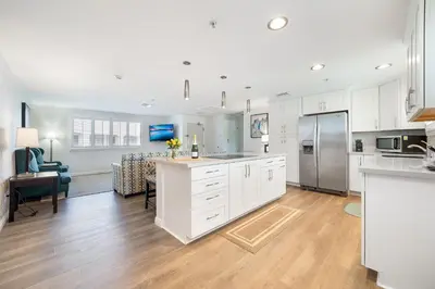 a kitchen with white cabinets and a dining room at Casablanca Inn in San Clemente