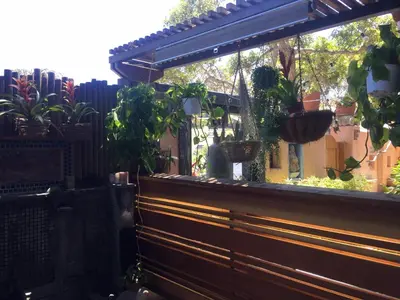 a wooden bench with potted plants on it at Les Artistes Inn in San Diego