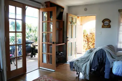a bedroom with a door open to a patio at Les Artistes Inn in San Diego