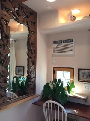 a mirror in a dining room with a plant at Les Artistes Inn in San Diego