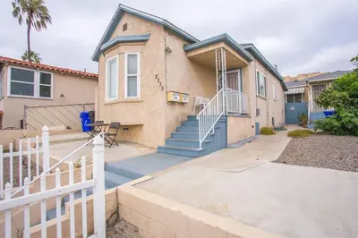 a house with a white fence in front of it at 3bd Little Italy Cottage A++ Location in San Diego