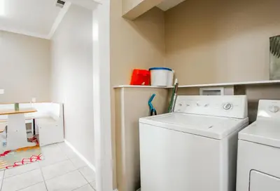a laundry room with a washer and dryer at 3bd Little Italy Cottage A++ Location in San Diego