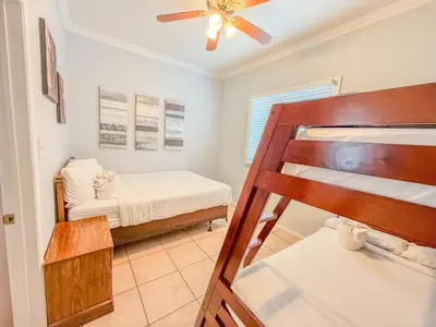 a small bedroom with a bunk bed and a ceiling fan at 3bd Little Italy Cottage A++ Location in San Diego