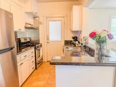 a kitchen with a vase of flowers on the counter at Mayor's Manor; Historic Downtown Mansion in San Diego