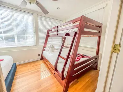a bedroom with two bunk beds in a room at Mayor's Manor; Historic Downtown Mansion in San Diego