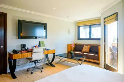 a living room with a desk and a couch at Balboa Inn, On The Beach At Newport in Newport Beach