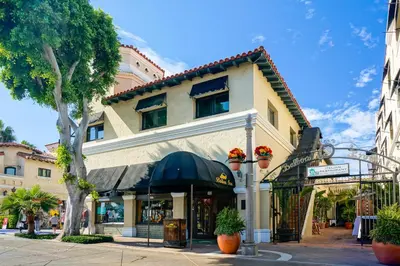 a building on a street with a store at Balboa Inn, On The Beach At Newport in Newport Beach