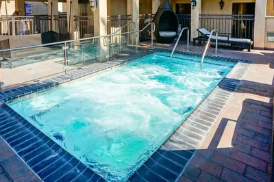 a swimming pool with blue water in a building at Balboa Inn, On The Beach At Newport in Newport Beach