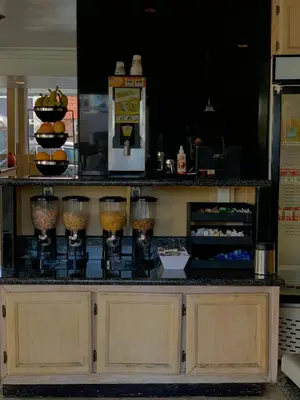 a counter in a restaurant with some food at Capri Laguna on the Beach - A Boutique Hotel in Laguna Beach