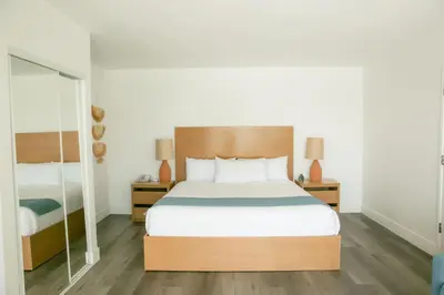 a bedroom with a bed and two night stands at Capri Laguna on the Beach - A Boutique Hotel in Laguna Beach
