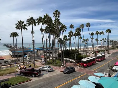 a view of a street with palm trees and a beach at Casa Tropicana in San Clemente