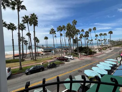 a view of a street with palm trees and a beach at Casa Tropicana in San Clemente