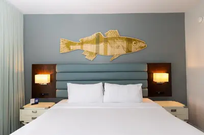 a bedroom with a bed with a fish on the wall at Lakehouse Resort in San Marcos