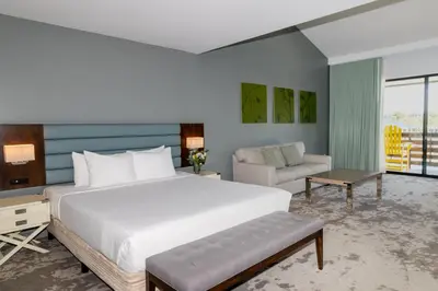 a bedroom with a large white bed and a couch at Lakehouse Resort in San Marcos